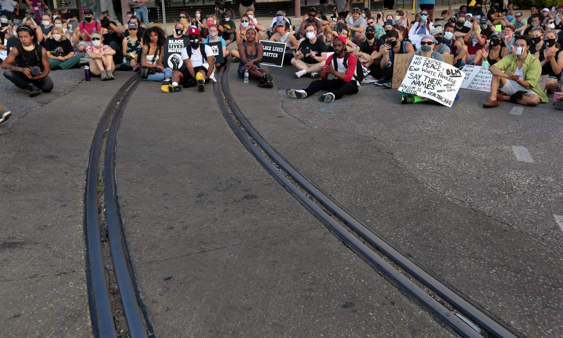 Protesters march through the Delmar Loop